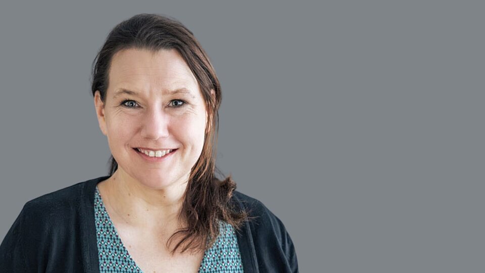 Dr. Anna Meins vor grauem Hintergrund. Seit 2010 arbeitet Dr. Anna Meins für das Sozialkontor, dabei seit 2023 als Fachreferentin Eingliederungshilfe. In dieser Funktion unterstützt sie fachlich-konzeptionell die Weiterentwicklung der Dienstleistungen, unter anderem im Feld der wirkungsorientierten Eingliederungshilfe sowie im Geschäftsbereich Teilhabe mit Pflege.