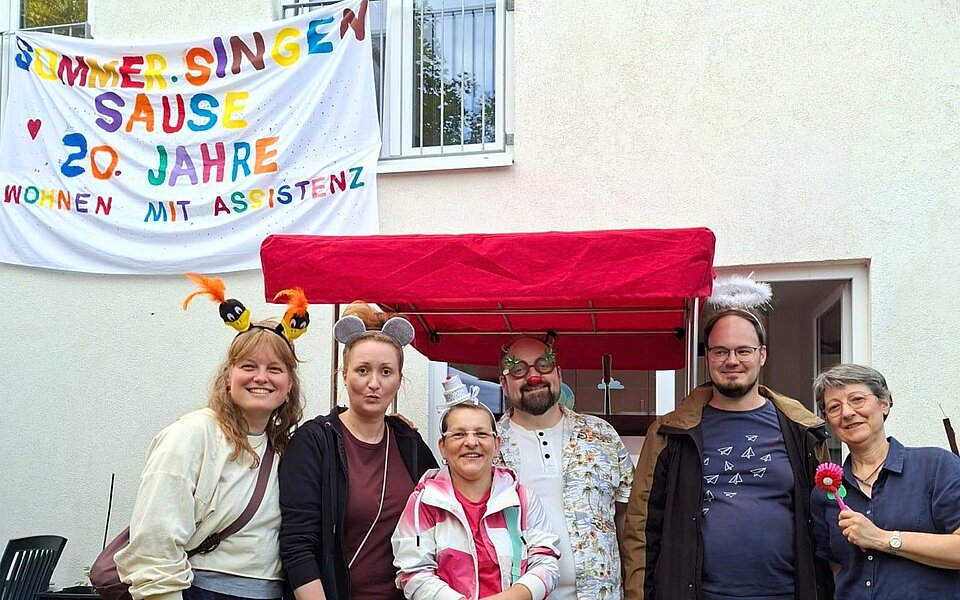 Mieter*innen, Mitarbeitende und Gäste bei der Jubiläumsfeier zu zehn Jahren Wohnen mit Assistenz Schellerdamm des Sozialkontors in Hamburg-Harburg.
